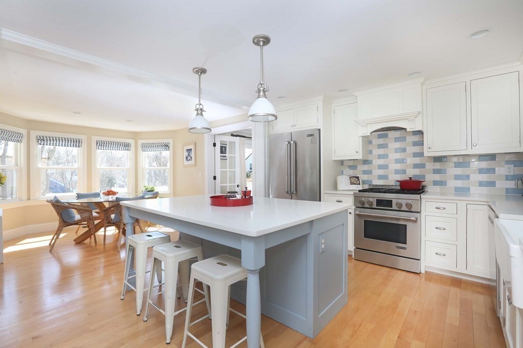 491 Webster Street Needham, MA 02494 - Photo 15 of 37 a kitchen with a stove a chandelier and a refrigerator