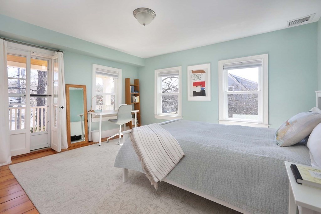 491 Webster Street Needham, MA 02494 - Photo 18 of 37 a spacious bedroom with a large bed and a window