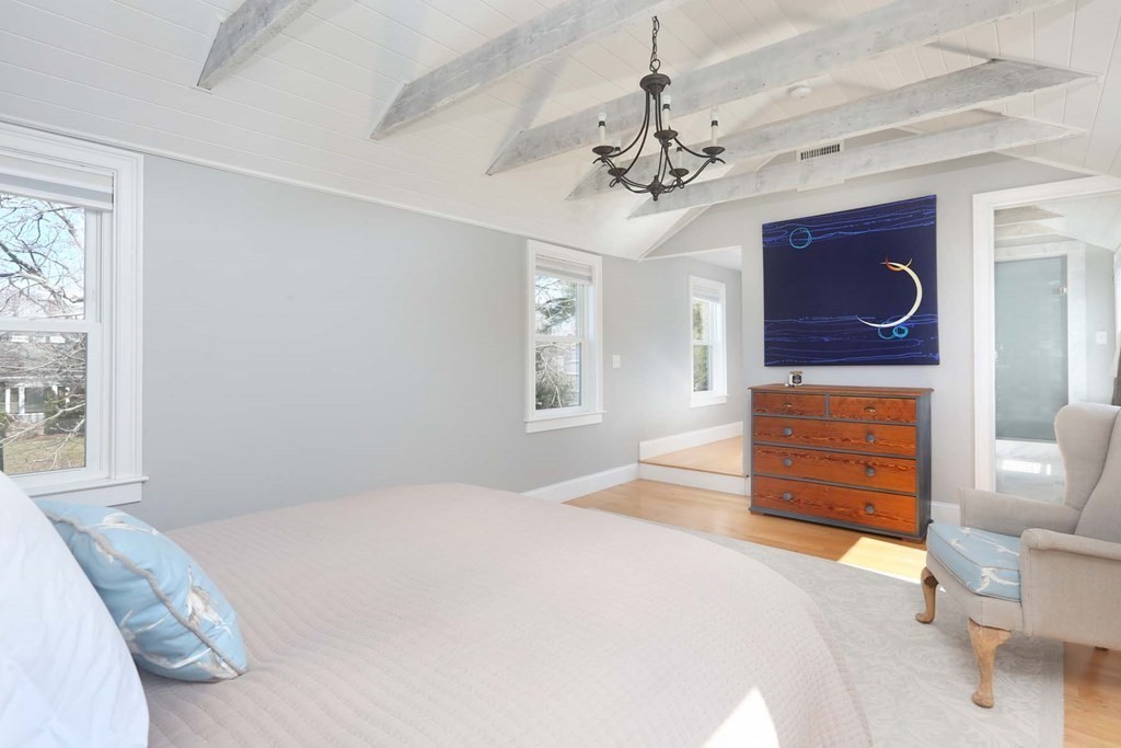 491 Webster Street Needham, MA 02494 - Photo 20 of 37 a bedroom with a bed a dresser and wooden floor