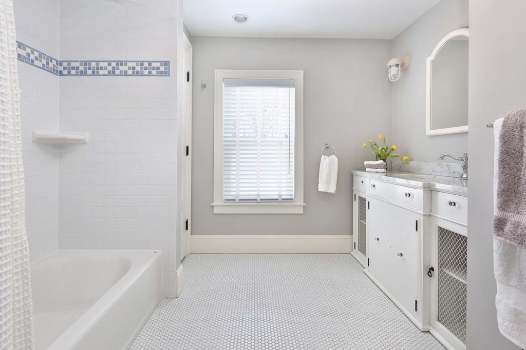 491 Webster Street Needham, MA 02494 - Photo 25 of 37 a bathroom with a bathtub sink and mirror