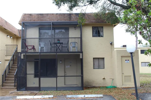 a front view of a house with iron fence