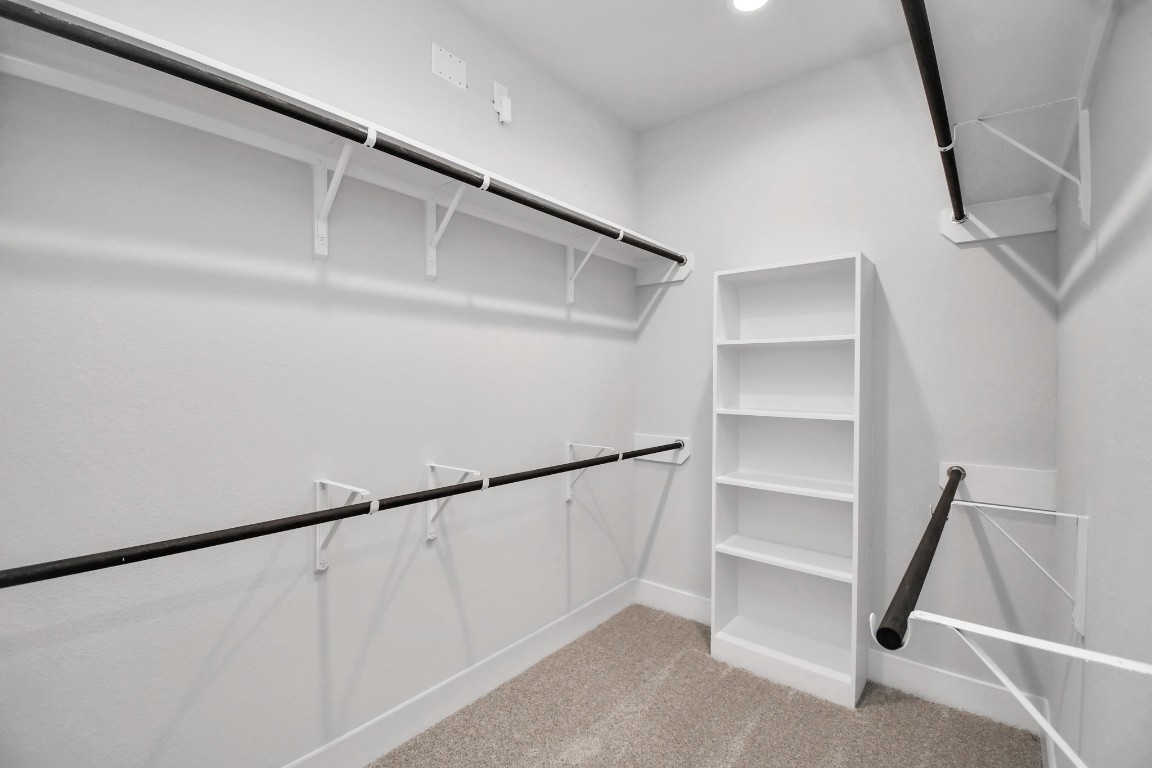 3123 Native Spg Drive Spring, TX 77373 - Photo 26 of 38 Walk-in closet that epitomizes luxury and practicality. This generously sized space features built-in shelving, offering abundant room for impeccable organization. High ceilings and recessed lighting create a bright and welcoming ambiance. Sample photo of completed home with similar floor plan. Actual colors and selections may vary.