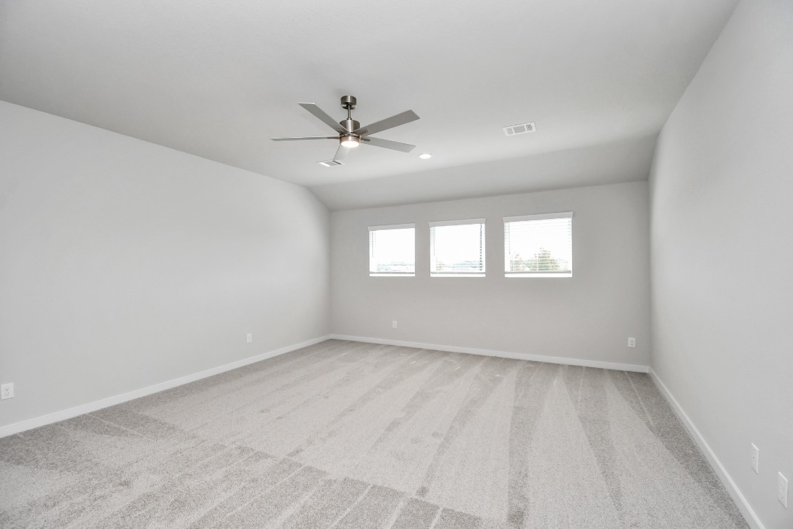 3123 Native Spg Drive Spring, TX 77373 - Photo 28 of 38 Ascend to relaxation in this fantastic game room! Ideal for both casual gatherings and adult gaming, it boasts plush carpet, lofty ceilings, custom paint, and ample windows for abundant natural light. Sample photo of completed home with similar floor plan. Actual colors and selections may vary.
