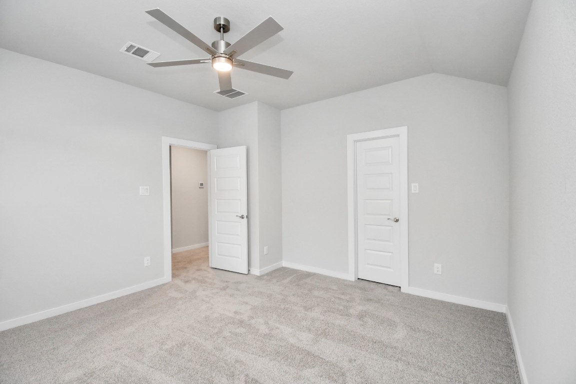 3123 Native Spg Drive Spring, TX 77373 - Photo 33 of 38 Generously sized secondary bedrooms featuring spacious closets, soft and inviting carpeting underfoot, large windows allowing plenty of natural light, and the added touch of privacy blinds for your personal retreat. Sample photo of completed home with similar floor plan. Actual colors and selections may vary.