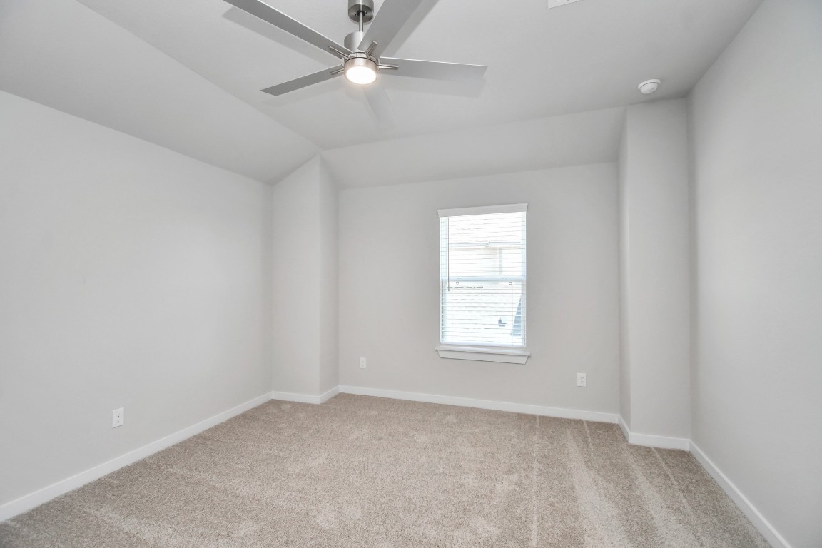 3123 Native Spg Drive Spring, TX 77373 - Photo 34 of 38 Secondary bedroom features plush carpeting, large windows that let in plenty of natural light, bright paint, and spacious closets. Sample photo of completed home with similar floor plan. Actual colors and selections may vary.