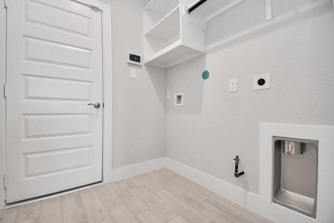 3123 Native Spg Drive Spring, TX 77373 - Photo 37 of 38 A perfect blend of functionality and comfort. Capture the essence of easy living with a first-floor laundry room, thoughtfully equipped with shelving for effortless organization. Both electric and gas connections available. Sample photo of completed home with similar floor plan. Actual colors and selections may vary.