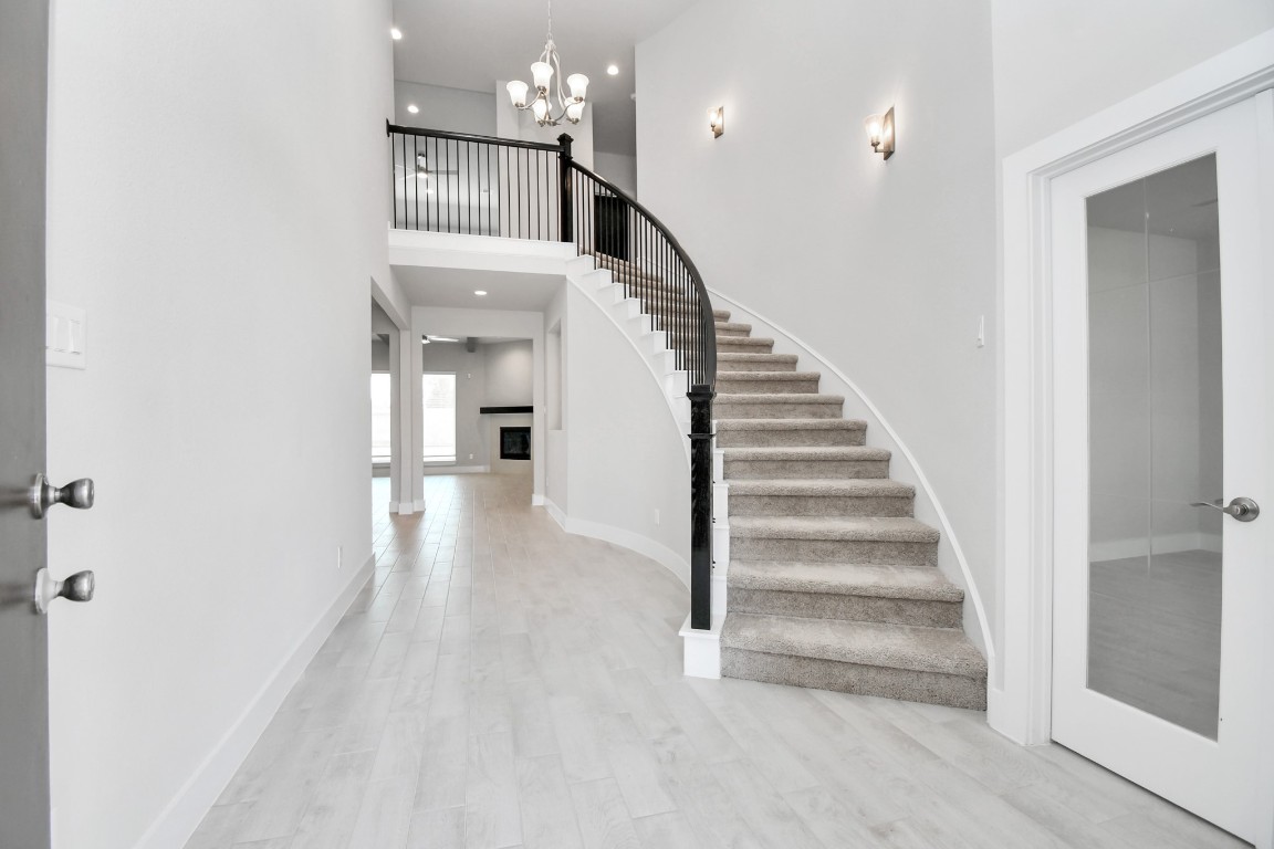 3123 Native Spg Drive Spring, TX 77373 - Photo 6 of 38 As you step into the threshold of this luxurious home, you'll soon be welcomed by an elegant glass door (to be installed). Inside, soaring ceilings amplify the spaciousness, while the refined wood-look tile flooring and oversized baseboards exude sophistication and charm. Sample photo of completed home with similar floor plan. Actual colors and selections may vary.