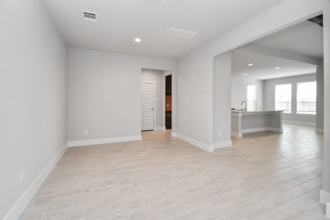 3123 Native Spg Drive Spring, TX 77373 - Photo 9 of 38 Create lasting memories with your family and friends at the dining table! This expansive dining room showcases sophisticated flooring, custom paint, and seamlessly connects to the family room and kitchen, providing an open and inviting atmosphere. Sample photo of completed home with similar floor plan. Actual colors and selections may vary.