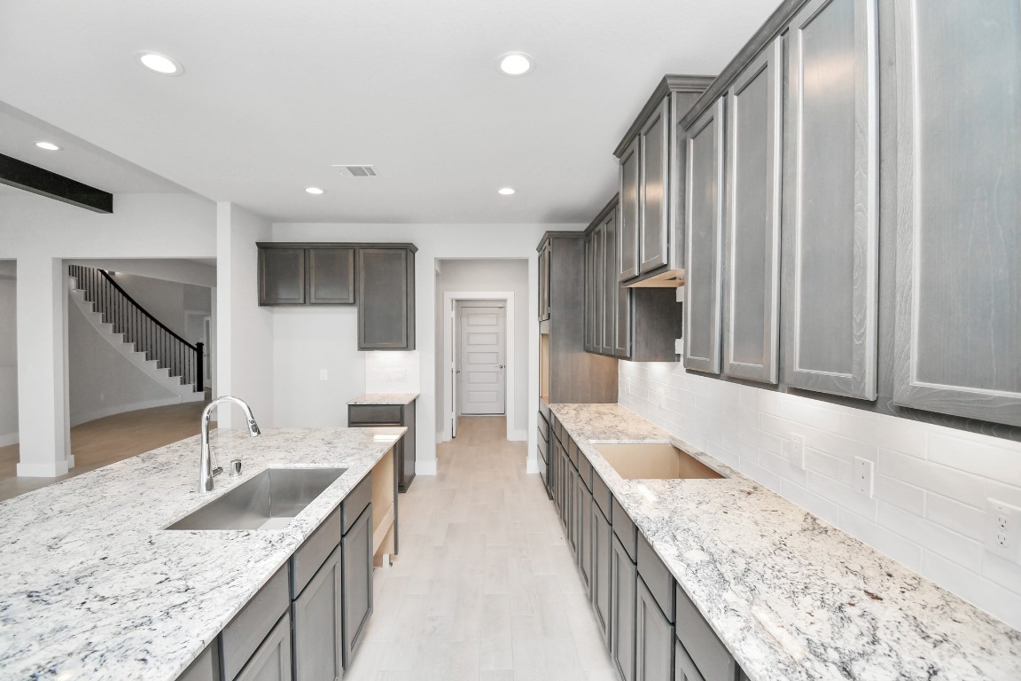3123 Native Spg Drive Spring, TX 77373 - Photo 12 of 38 The extended counter area adds both practicality and style, making meal preparation a breeze. Every detail is thoughtfully designed to enhance the kitchen's functionality and aesthetic appeal. Sample photo of completed home with similar floor plan. Actual colors and selections may vary.