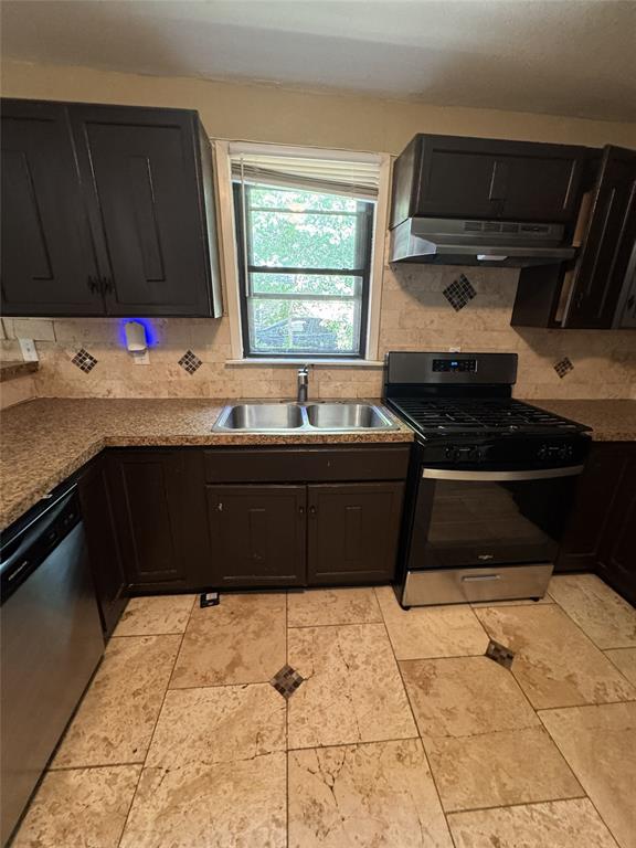 803 Ripley Avenue Ennis, TX 75119 - Photo 12 of 40 Kitchen featuring dark wood cabinetry, a double basin stainless steel sink, and a stainless steel range with overhead ventilation
