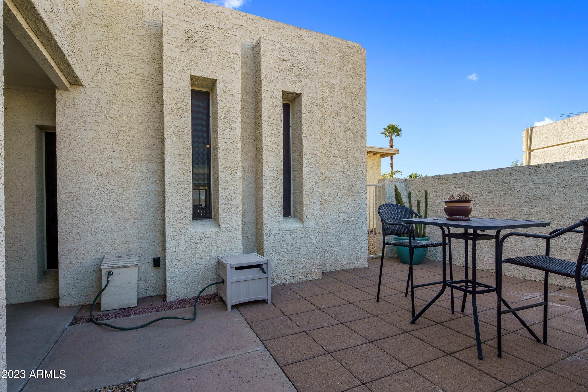 6609 East Phelps Road Scottsdale, AZ 85254 - Photo 39 of 83 a patio with table and chairs and potted plants