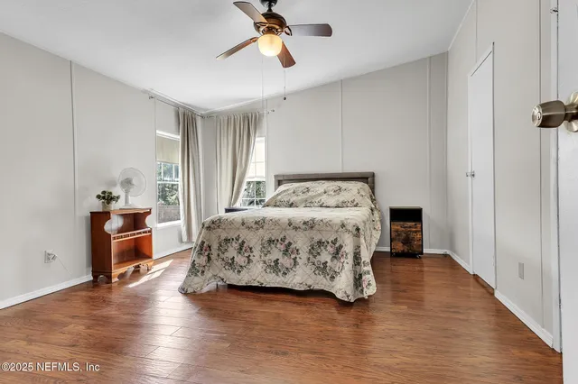 a bedroom with a bed and wooden floor