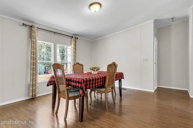a view of a dining room with furniture and wooden floor