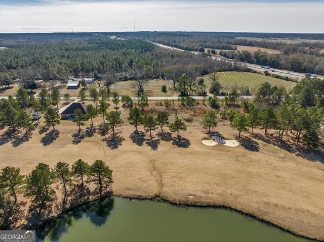 a view of a lake with trees all around