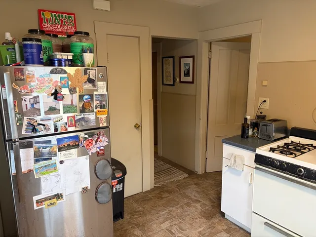 a kitchen with a refrigerator and a stove