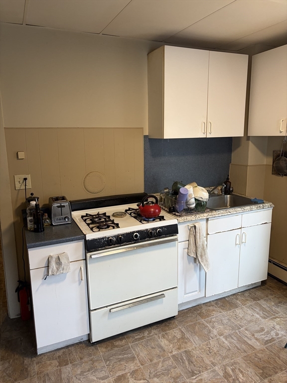 53 Oak Street, Unit 2 Somerville, MA 02143 - Photo 3 of 12 a white stove top oven sitting inside of a kitchen