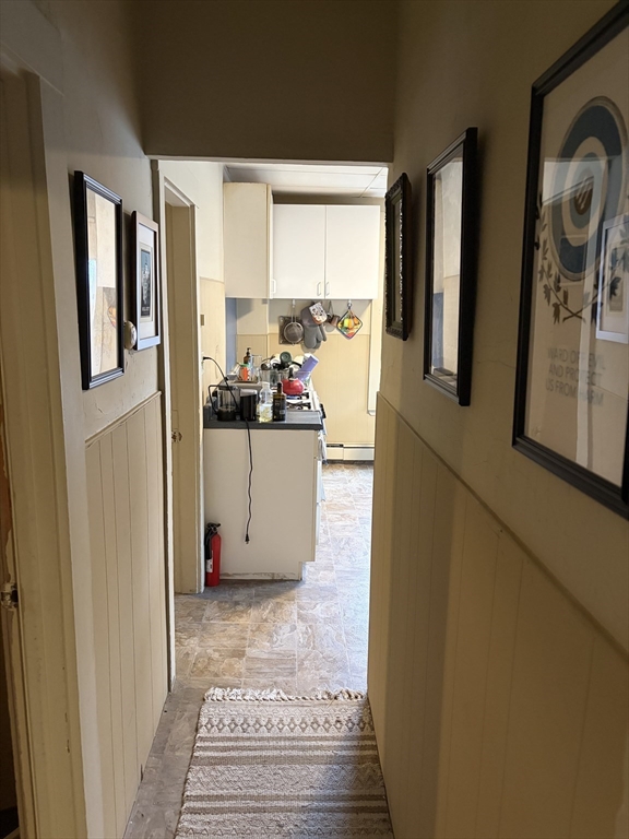 53 Oak Street, Unit 2 Somerville, MA 02143 - Photo 5 of 12 a view of a kitchen with fridge and wooden floor