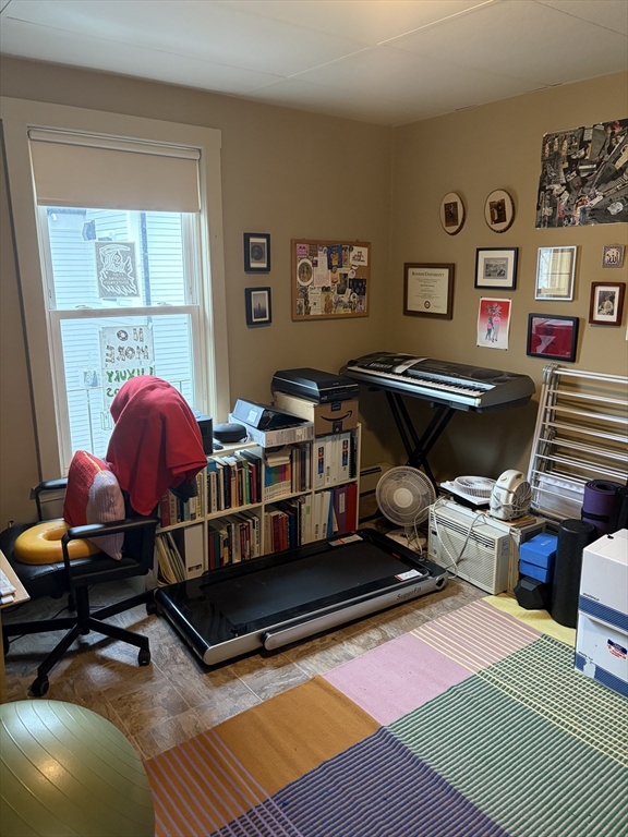 53 Oak Street, Unit 2 Somerville, MA 02143 - Photo 7 of 12 a living room with furniture a rug and wall paintings