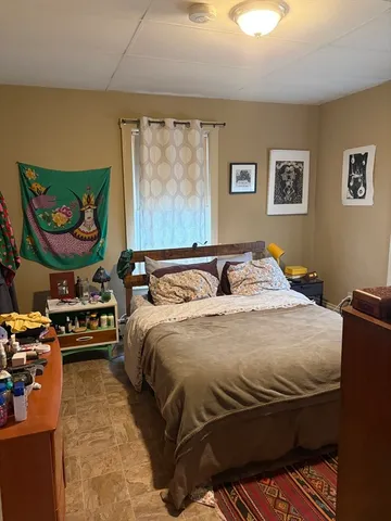 a bedroom with a bed and dresser