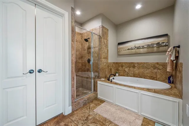 a bathroom with a tub a sink and mirror