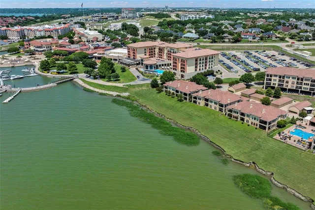 an aerial view of city lake and trees all around