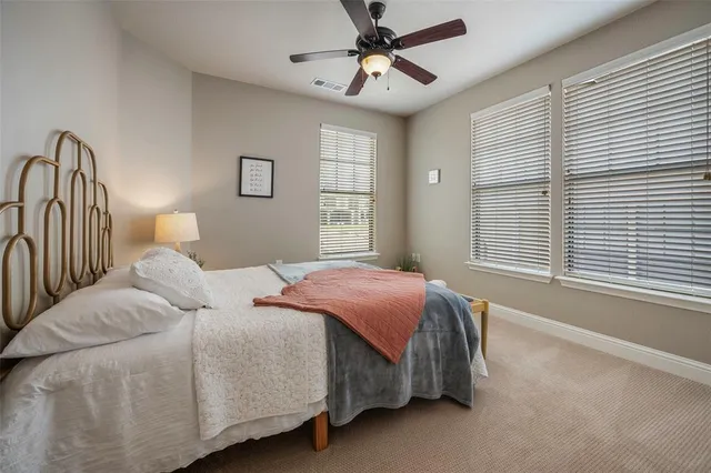 a bedroom with a bed next to a window