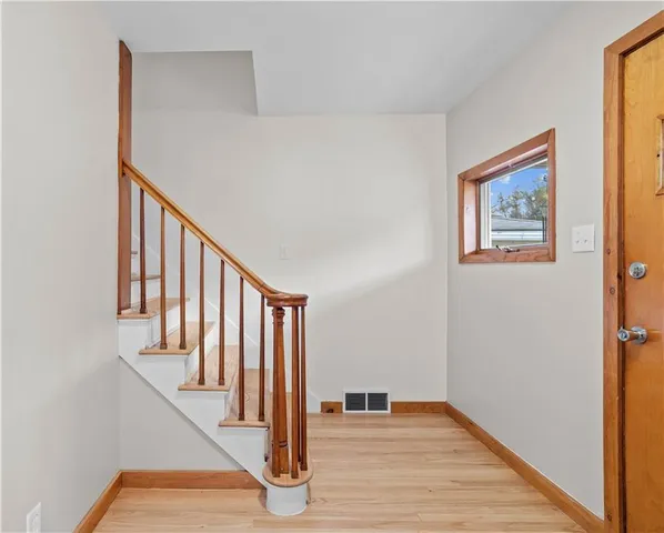 a view of an entryway with wooden floor