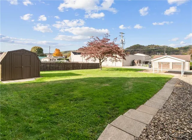 a front view of a house with a garden and yard