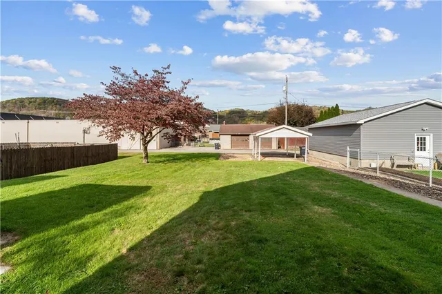 a front view of a house with a yard and table and chairs