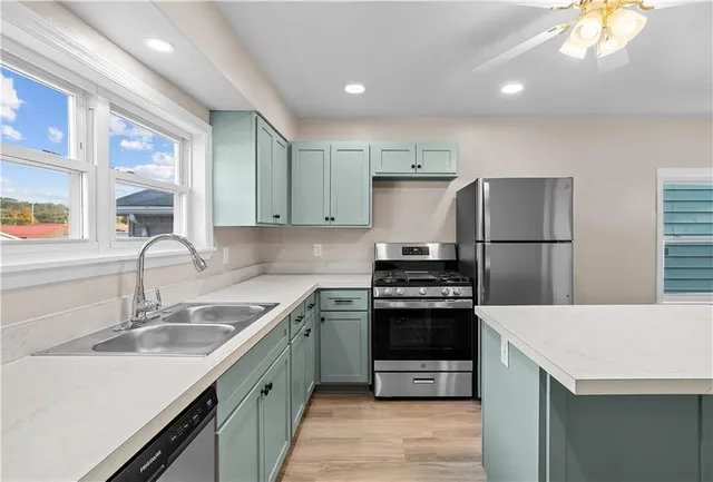 a kitchen with a sink appliances and cabinets