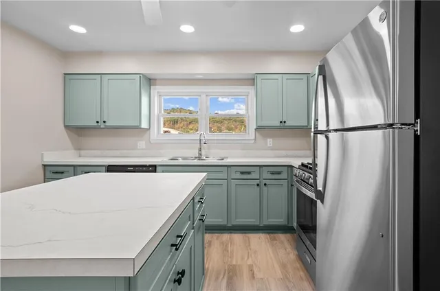 a kitchen with a refrigerator sink and stove