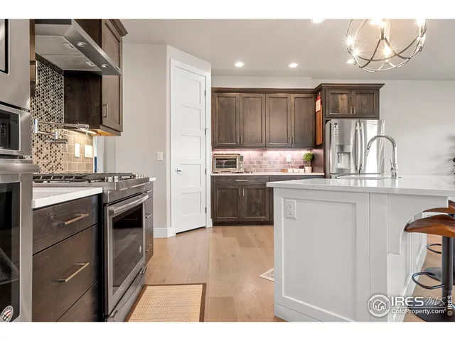 a kitchen with stainless steel appliances kitchen island granite countertop a stove a sink and a microwave