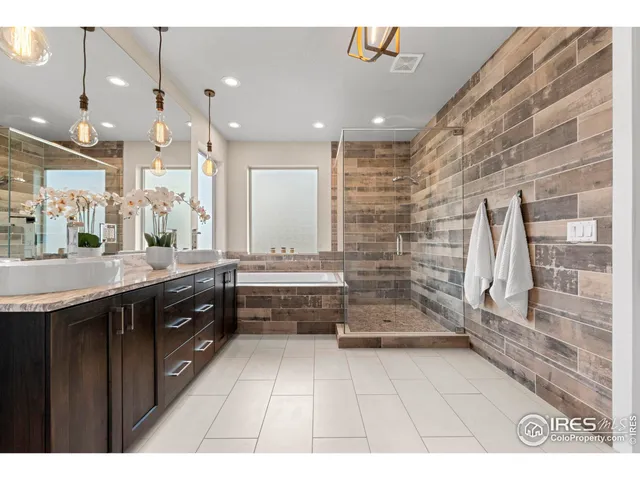 a large bathroom with a large tub and sink