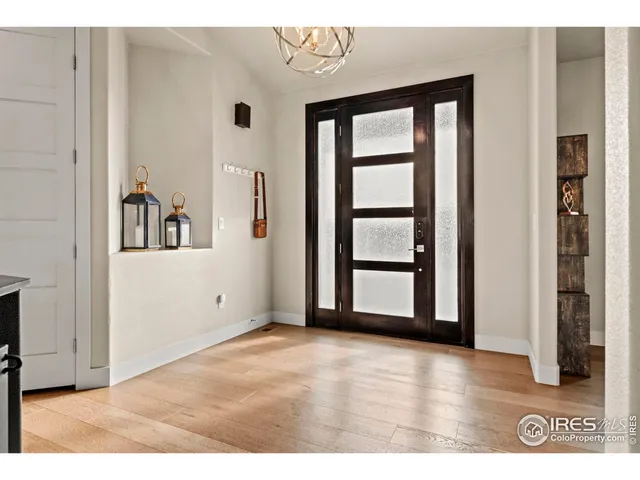 a view of a big room with wooden floor and windows