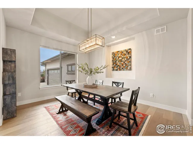 a dining room with a wooden table and chairs