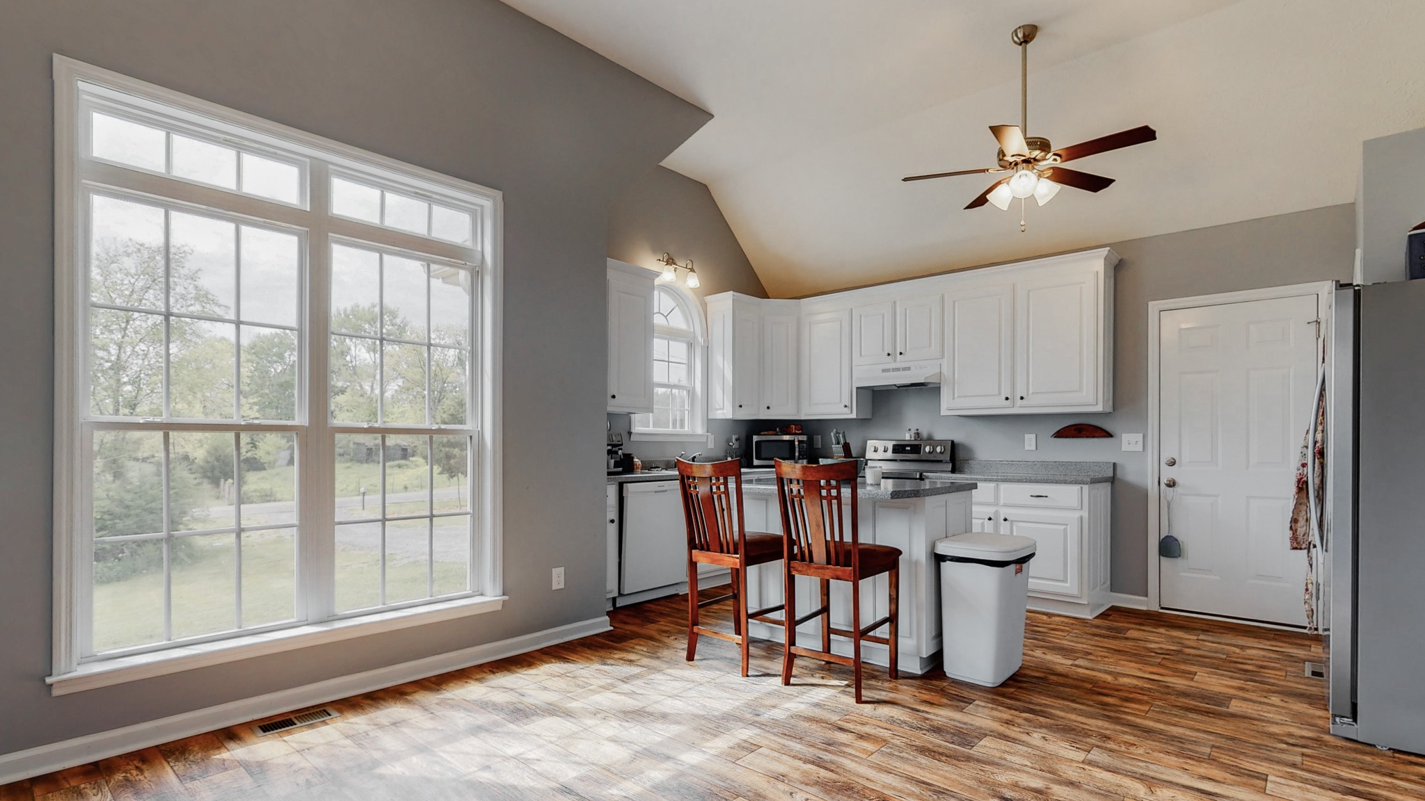 10 South Howard Fitch Road Fayetteville, TN 37334 - Photo 17 of 40 a kitchen with stainless steel appliances kitchen island granite countertop a refrigerator a stove top oven a sink a dining table and chairs with wooden floor