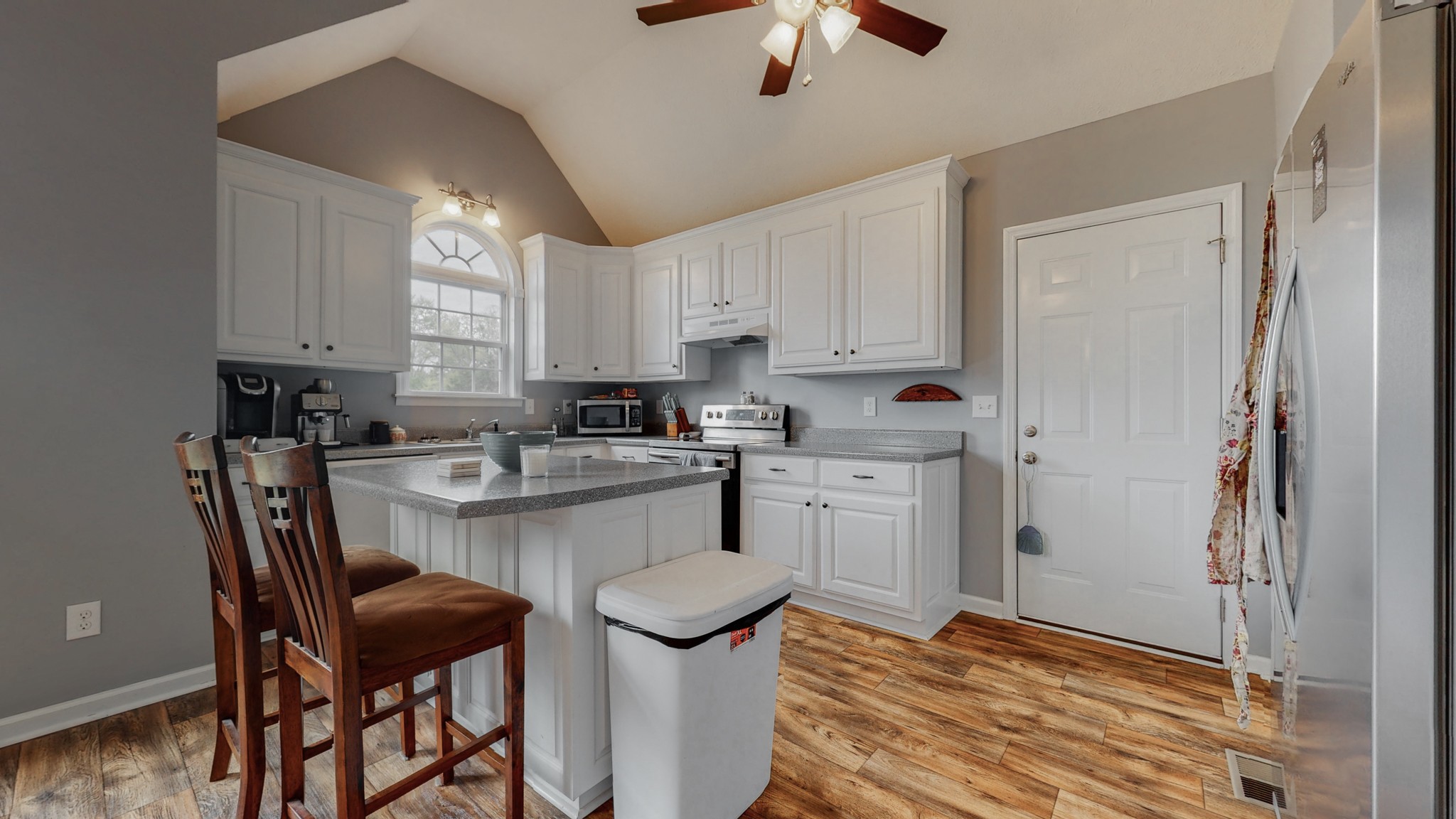 10 South Howard Fitch Road Fayetteville, TN 37334 - Photo 3 of 40 a kitchen with stainless steel appliances kitchen island a table chairs sink and cabinets