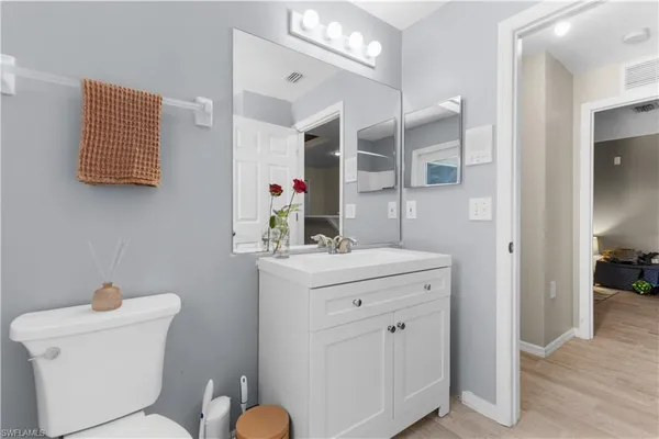 a bathroom with a sink a toilet and mirror