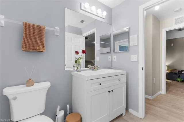 a bathroom with a sink a toilet and mirror