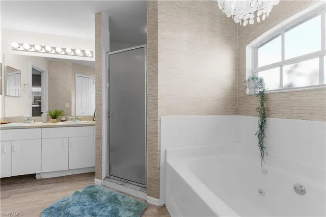 a bathroom with a bathtub a sink and a window