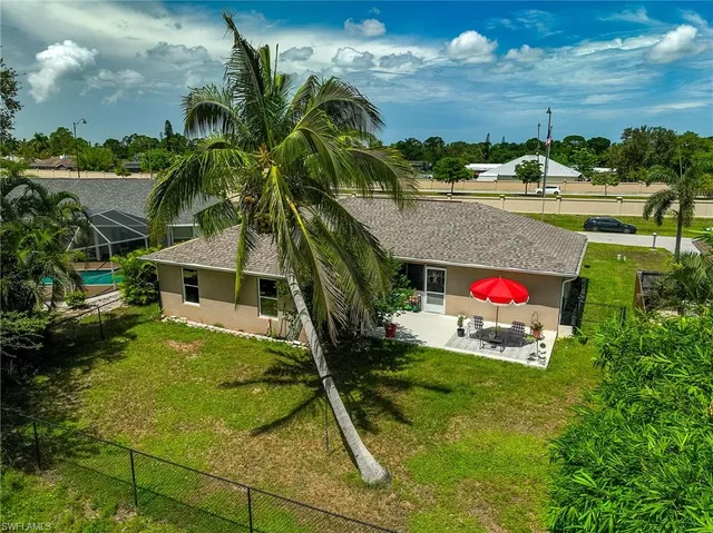 a view of swimming pool with a yard and a fountain