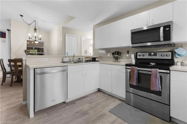 a kitchen with a sink stove and microwave