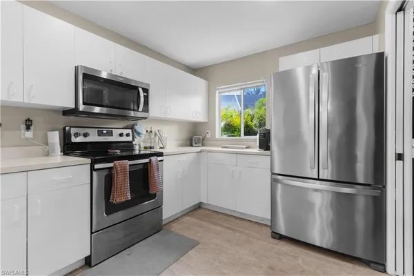 a kitchen with stainless steel appliances a refrigerator stove and microwave