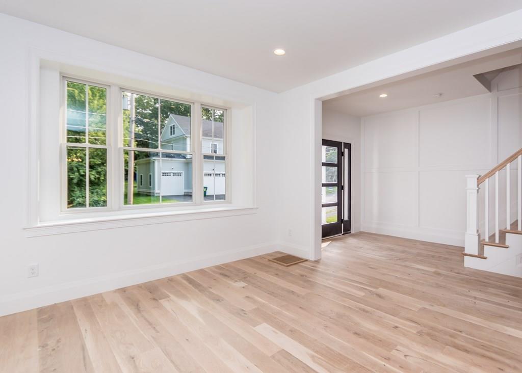56 Pershing Road Needham, MA 02494 - Photo 2 of 42 a view of an empty room with a window and wooden floor