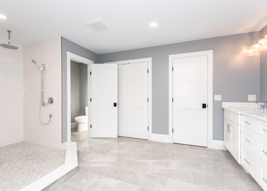 56 Pershing Road Needham, MA 02494 - Photo 23 of 42 a view of a bathroom with a tub shower and sink