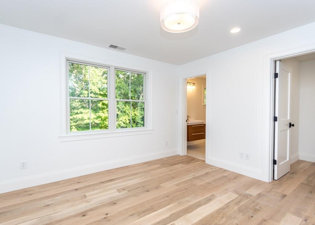 56 Pershing Road Needham, MA 02494 - Photo 25 of 42 an empty room with wooden floor and windows