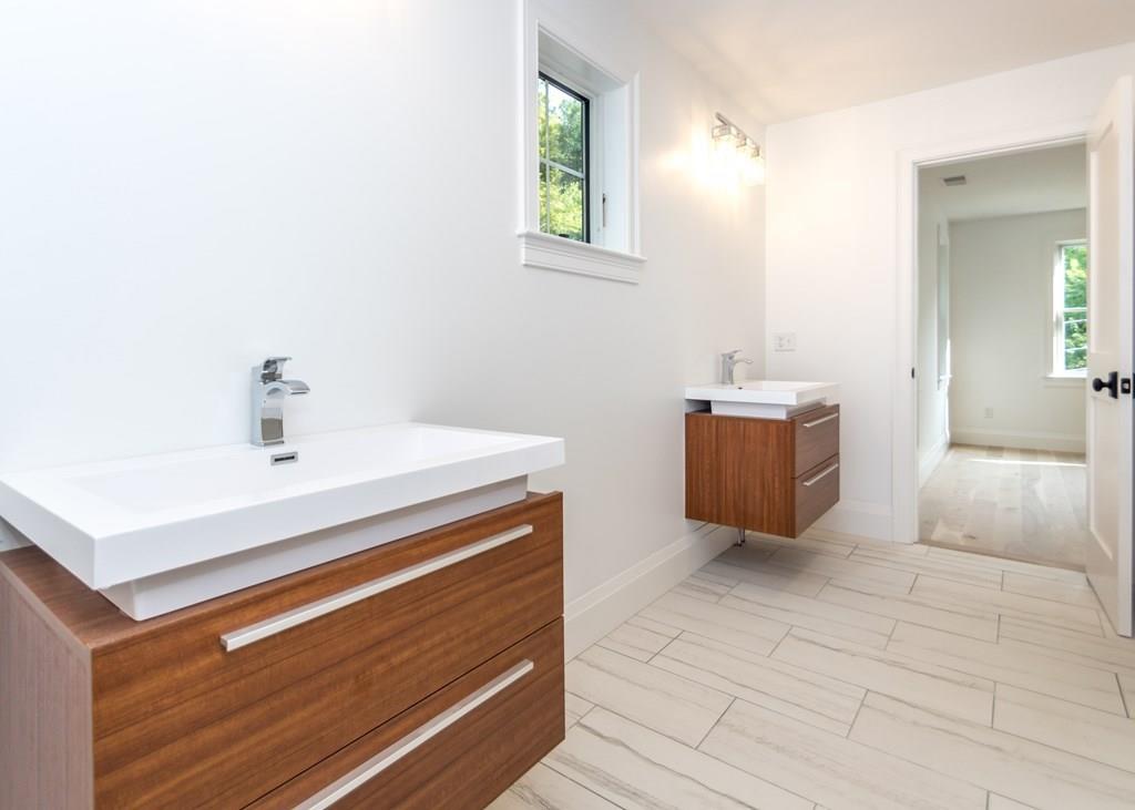 56 Pershing Road Needham, MA 02494 - Photo 26 of 42 a bathroom with a sink a mirror and vanity
