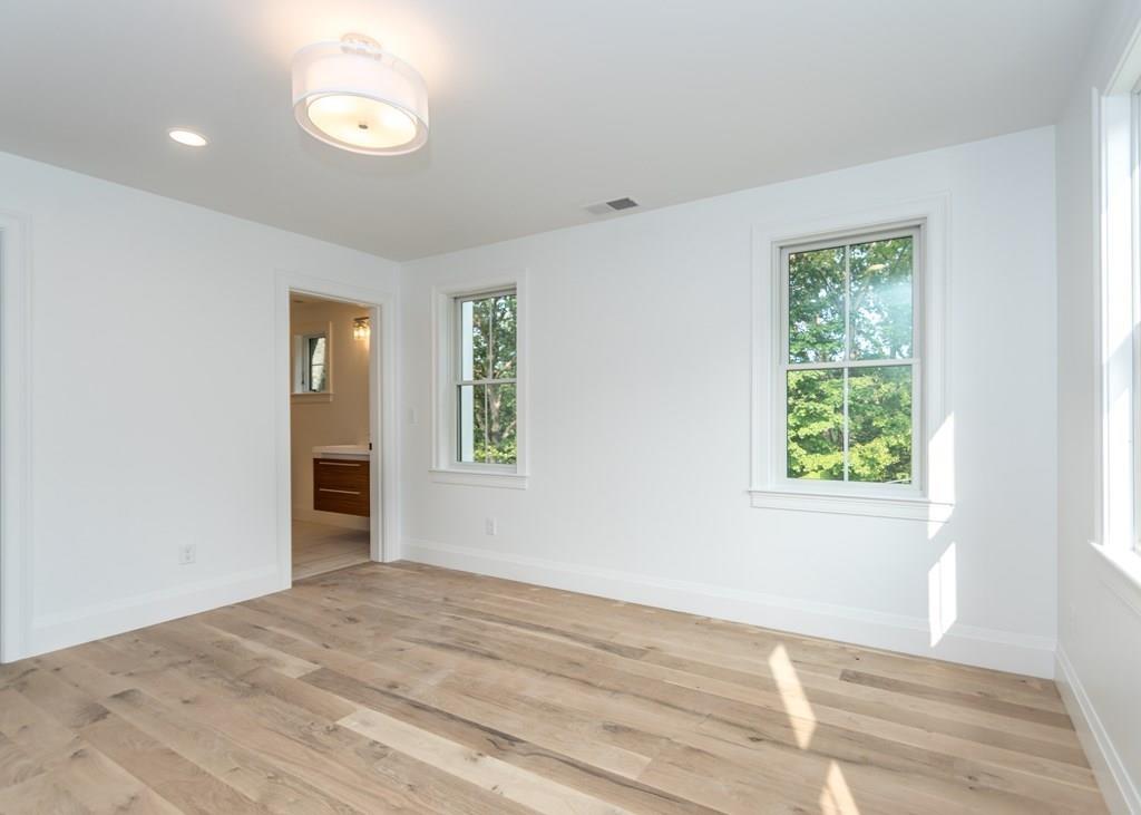 56 Pershing Road Needham, MA 02494 - Photo 27 of 42 a view of an empty room with wooden floor and a window