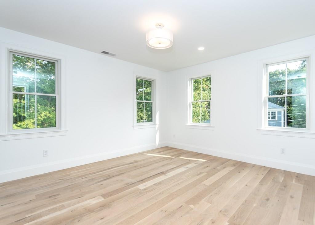 56 Pershing Road Needham, MA 02494 - Photo 28 of 42 a view of an empty room with wooden floor and a window