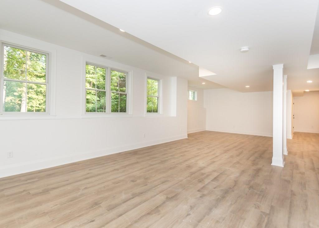 56 Pershing Road Needham, MA 02494 - Photo 33 of 42 an empty room with wooden floor and windows